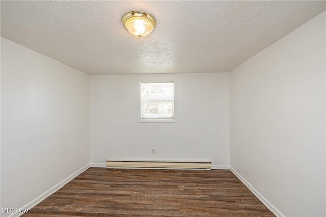 empty room featuring a textured ceiling, a baseboard radiator, and dark hardwood / wood-style flooring