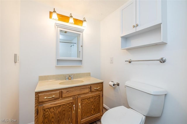 bathroom featuring toilet and vanity