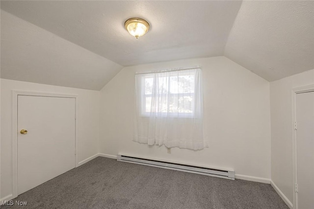 additional living space featuring carpet floors, a baseboard radiator, and lofted ceiling