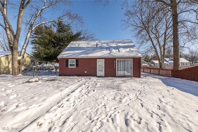 view of snow covered back of property