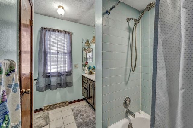 bathroom with tiled shower / bath combo, a textured ceiling, tile patterned floors, and vanity