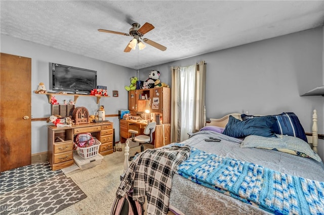 bedroom featuring a textured ceiling, ceiling fan, and carpet flooring