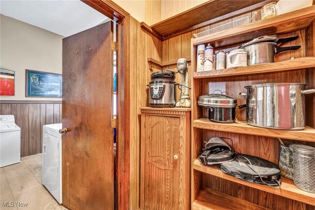 interior space featuring washing machine and dryer and wooden walls