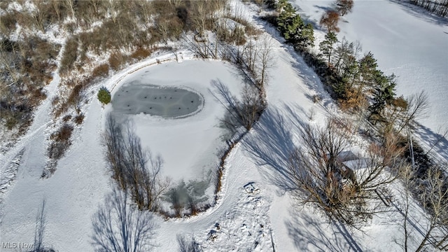 snowy aerial view featuring a water view