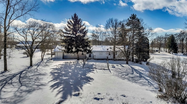 snowy yard featuring a garage