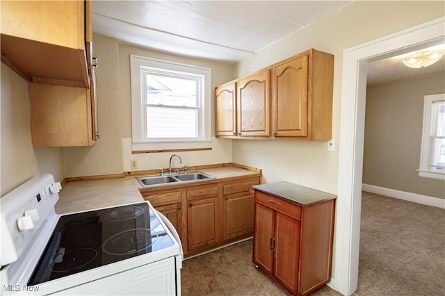 kitchen with sink, light carpet, a wealth of natural light, and white electric range oven