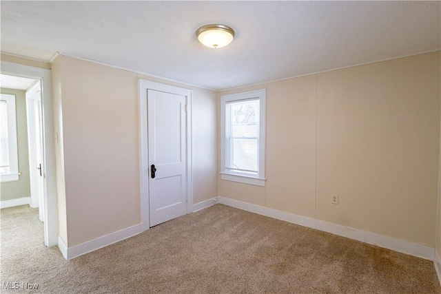 unfurnished bedroom featuring light colored carpet