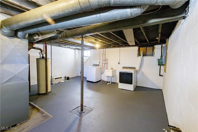 basement with water heater, washing machine and dryer, heating unit, and sink