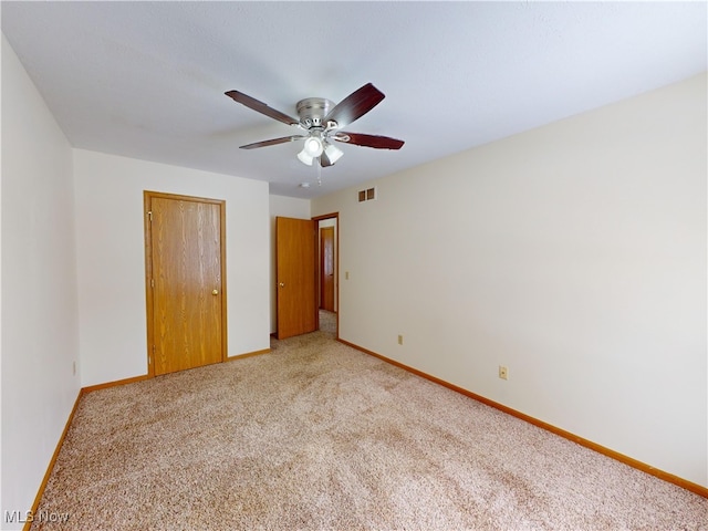 unfurnished bedroom with a closet, ceiling fan, and carpet flooring