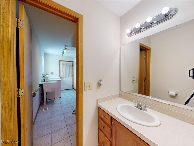 bathroom featuring tile patterned flooring and vanity