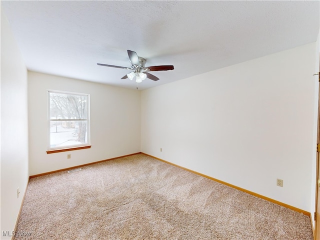 empty room with ceiling fan and carpet