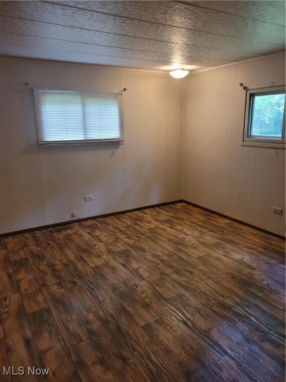 empty room featuring dark hardwood / wood-style flooring