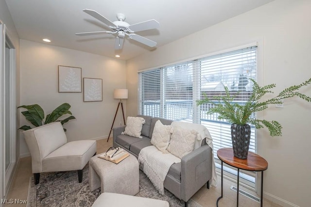 carpeted living room featuring ceiling fan and a healthy amount of sunlight