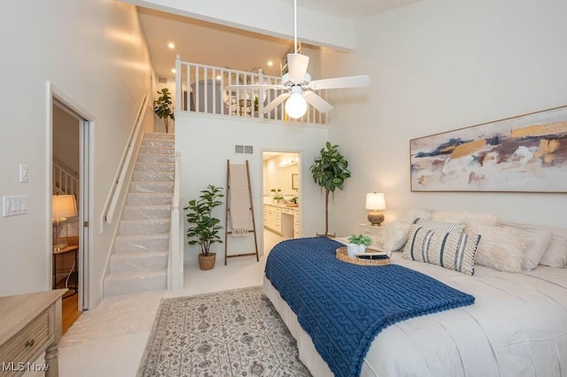 bedroom with high vaulted ceiling, ceiling fan, beamed ceiling, and connected bathroom