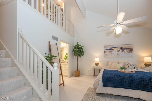 carpeted bedroom featuring high vaulted ceiling and ceiling fan