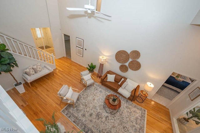 living room featuring ceiling fan and wood-type flooring