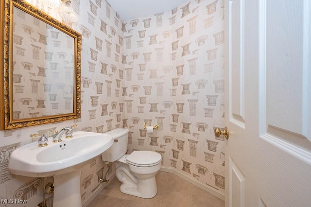 bathroom with toilet and tile patterned floors