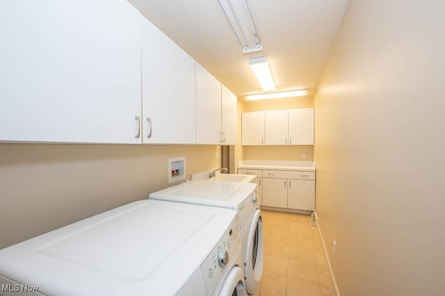 laundry area featuring sink, cabinets, and independent washer and dryer