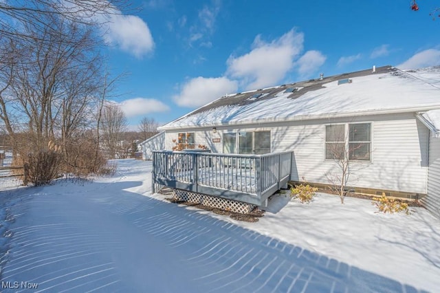 snow covered property featuring a deck