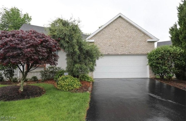 view of front of home with a garage and a front yard