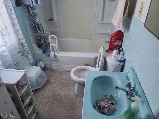 full bathroom featuring sink, tile walls, toilet, and shower / bath combo with shower curtain