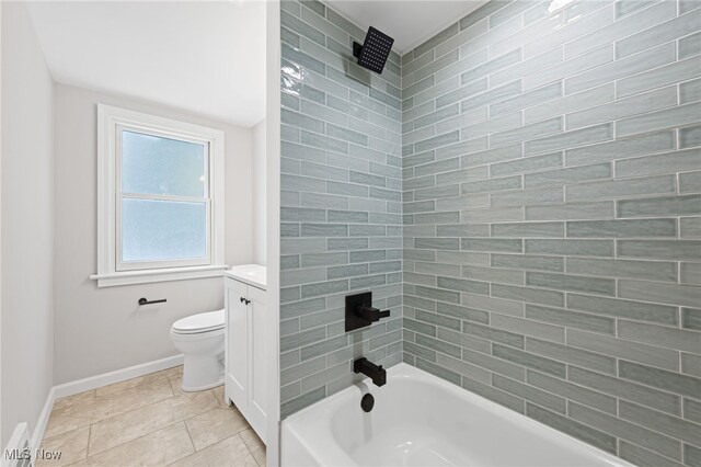 full bathroom with toilet, tiled shower / bath, tile patterned floors, and vanity