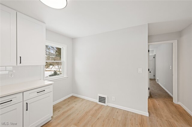 unfurnished dining area featuring light hardwood / wood-style floors