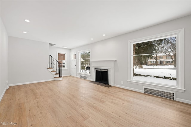 unfurnished living room with light wood-type flooring