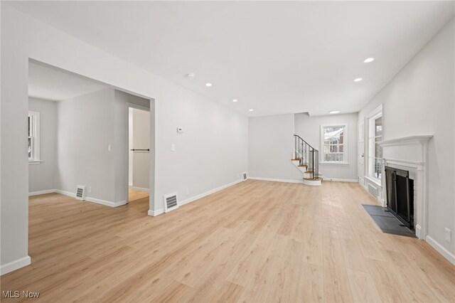 unfurnished living room with light wood-type flooring