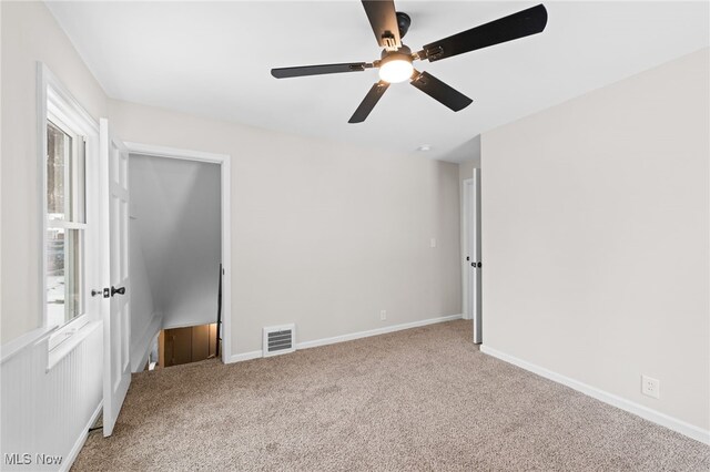 spare room with ceiling fan and carpet flooring