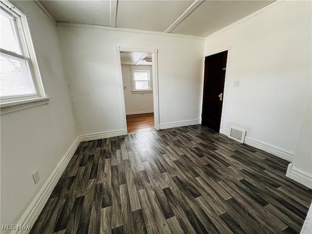 empty room with dark hardwood / wood-style flooring