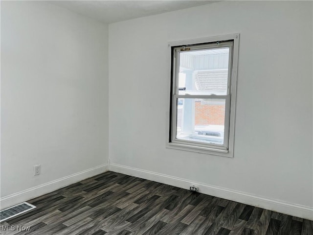 unfurnished room featuring dark hardwood / wood-style flooring