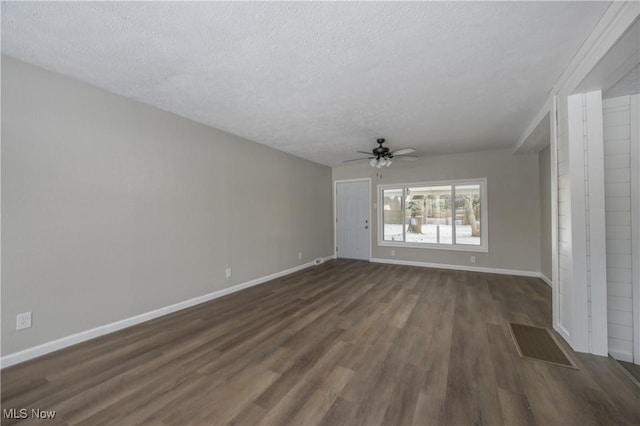 spare room with a textured ceiling, ceiling fan, and dark hardwood / wood-style floors