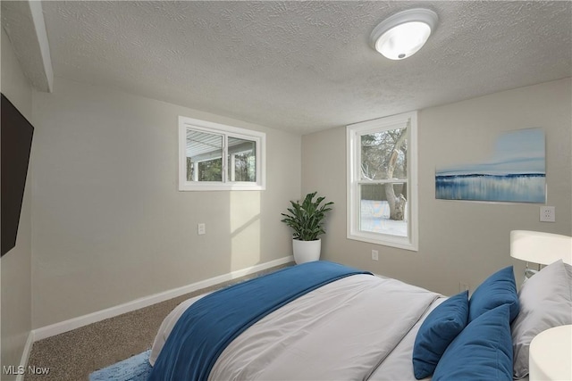 carpeted bedroom with a textured ceiling