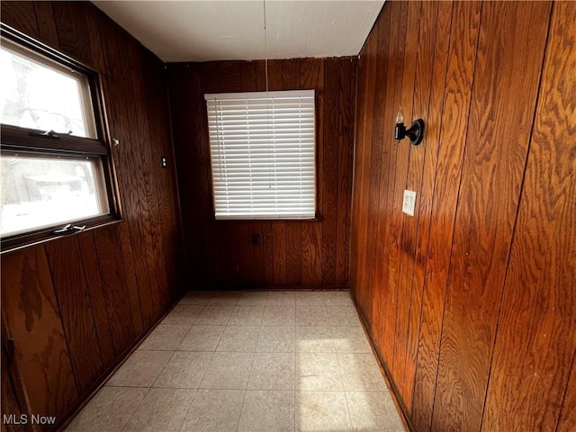 spare room featuring wooden walls