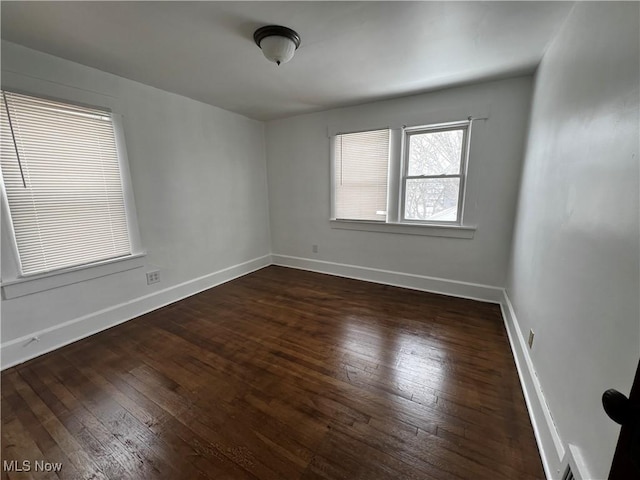 spare room with dark wood-type flooring