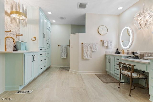 bathroom featuring a chandelier and vanity