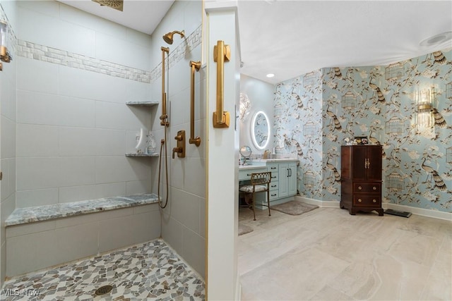 bathroom featuring a shower and vanity