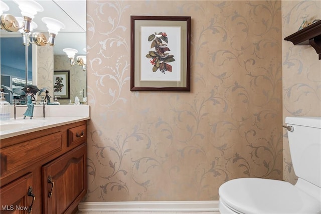 bathroom with toilet and vanity