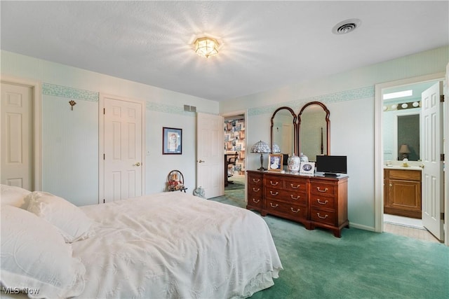 bedroom featuring light colored carpet and ensuite bath