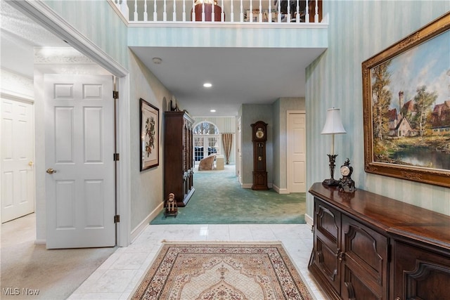 hall featuring light colored carpet