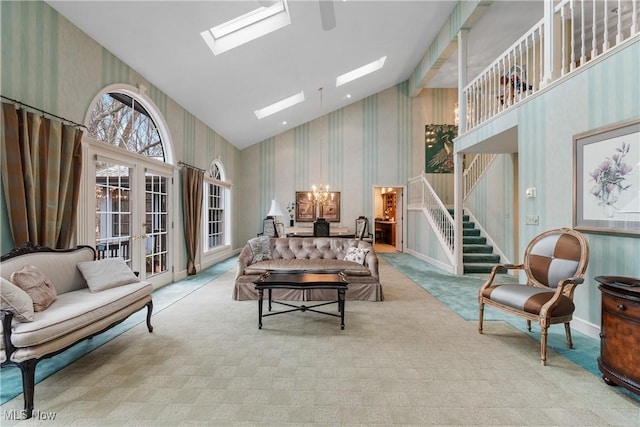 living room with high vaulted ceiling, light colored carpet, and french doors