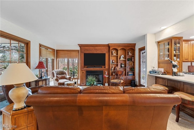 carpeted living room featuring a fireplace