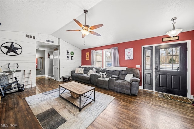 living room with wood finished floors, visible vents, ceiling fan, vaulted ceiling, and a textured ceiling