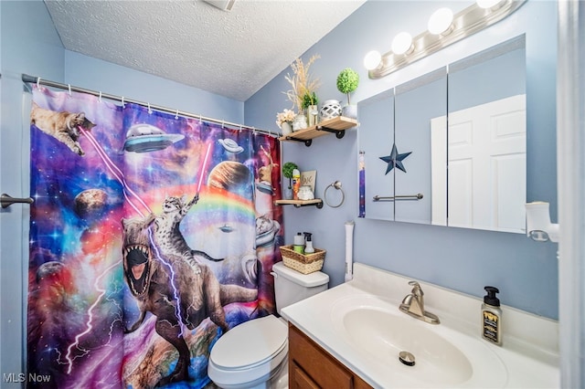 bathroom featuring toilet, a textured ceiling, and vanity