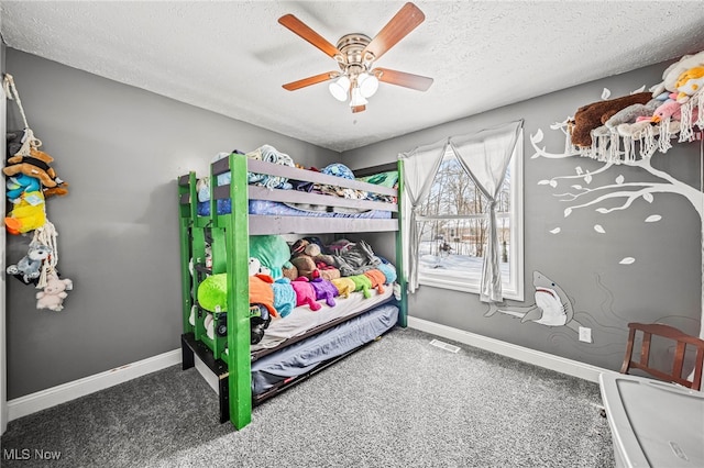 carpeted bedroom with a textured ceiling and ceiling fan