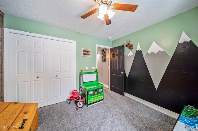 game room with ceiling fan, carpet, baseboards, and a textured ceiling
