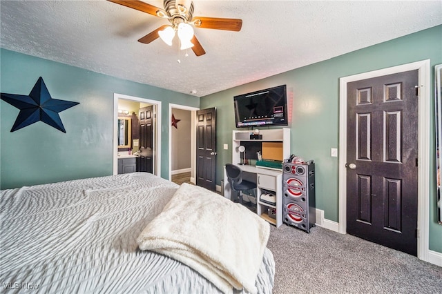 carpeted bedroom with ceiling fan, connected bathroom, and a textured ceiling