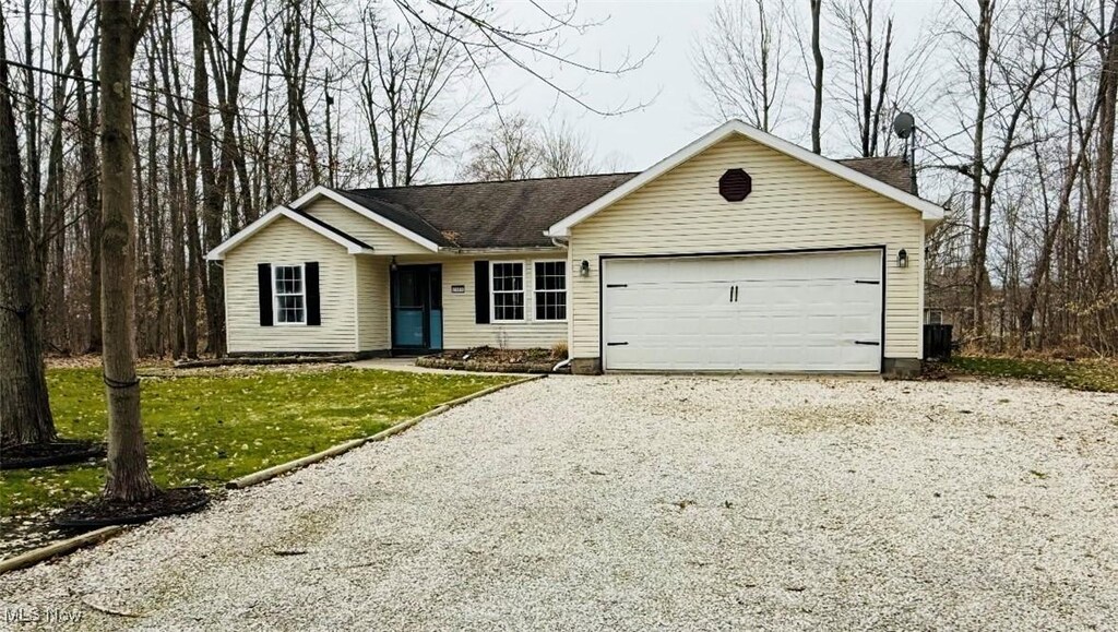 2000 Flame Lake Dr, Roaming Shores, OH 44084 - ranch-style house with an attached garage and driveway