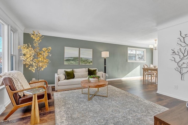 living room featuring a chandelier and dark hardwood / wood-style floors